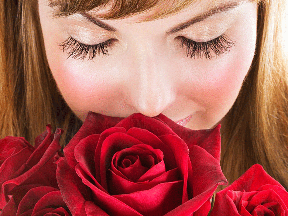Woman smelling roses
