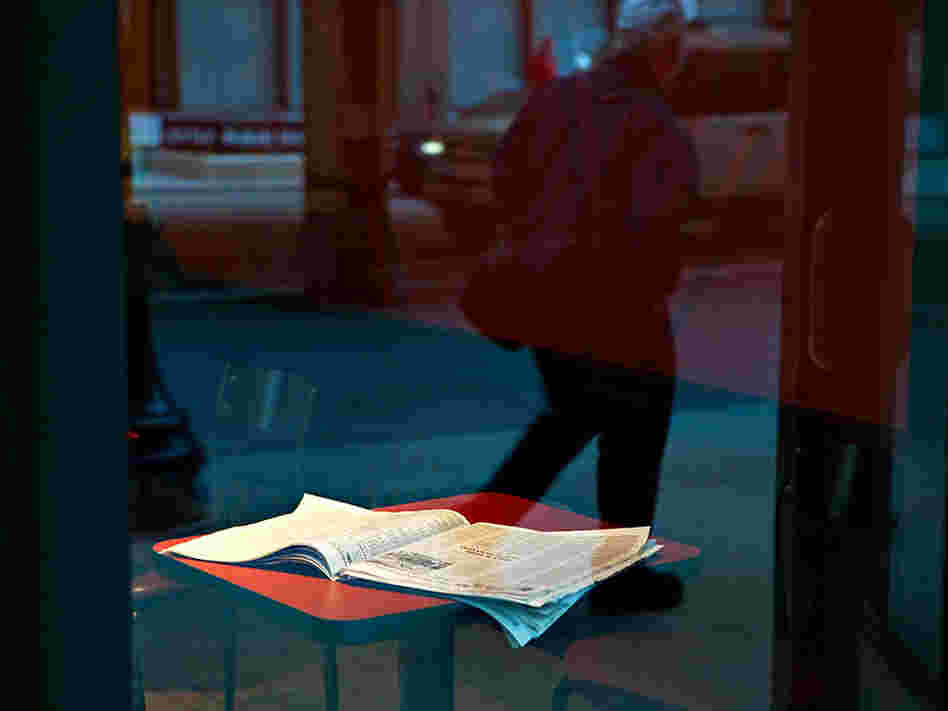 An open newspaper on a cafe table