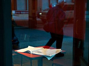 An open newspaper on a cafe table An open newspaper on a cafe table