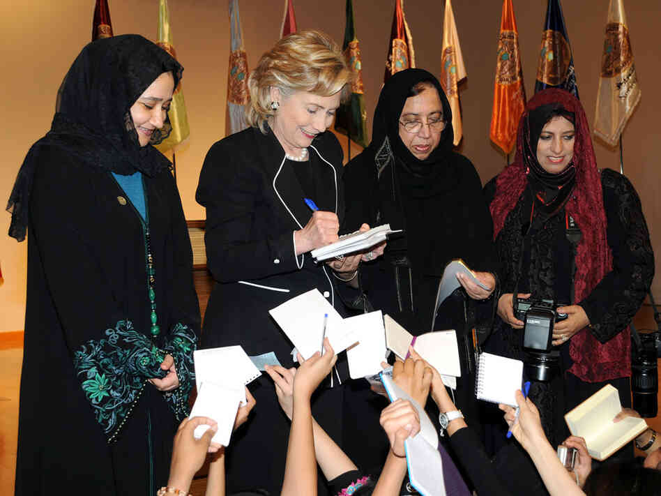 Secretary of State Hillary Clinton gives her autograph to students in Jeddah, Saudi Arabia.