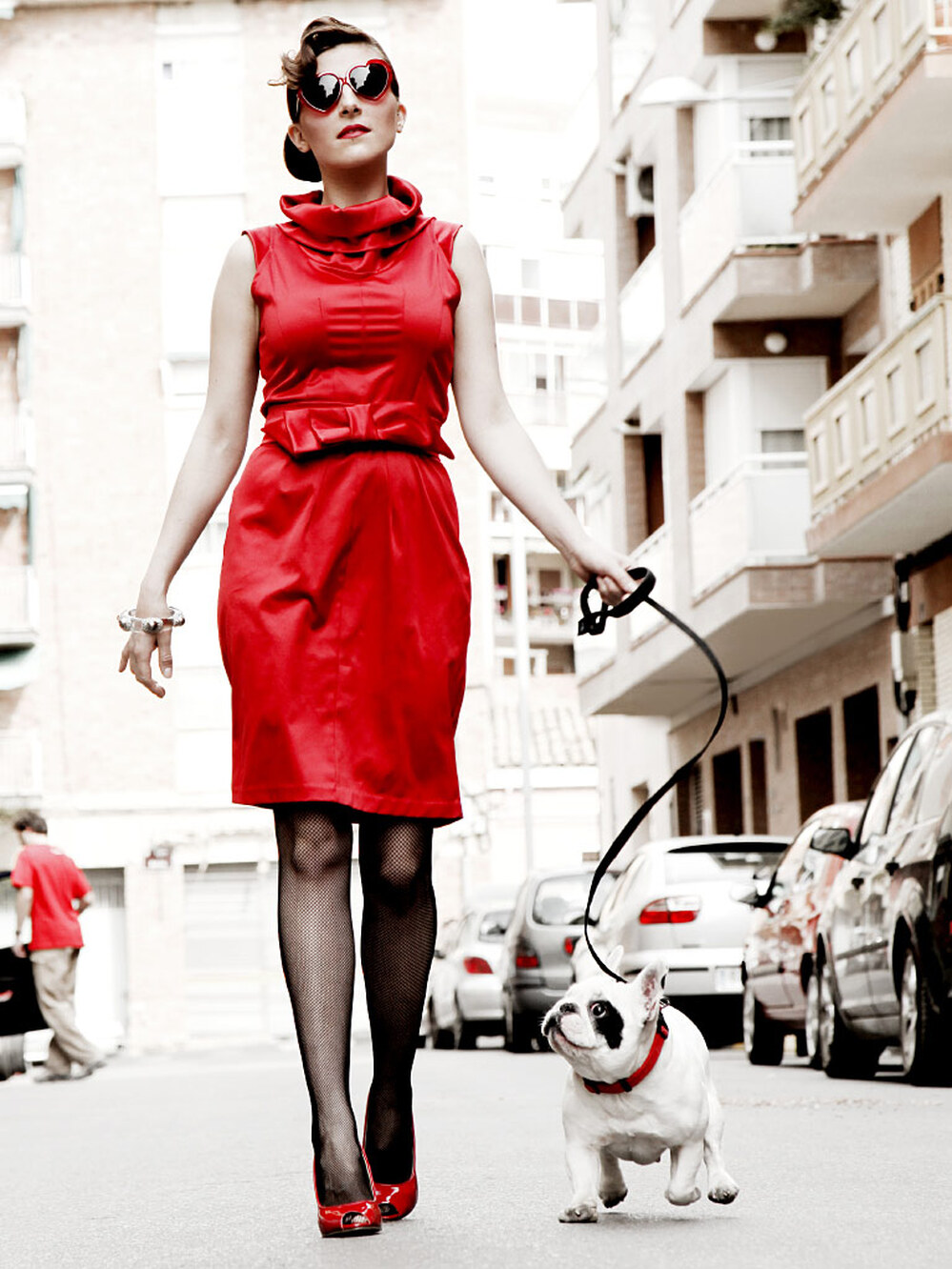 A fancy woman walks her dog.