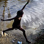A girl jumps across a flooded field in Port-au-Prince. A girl jumps across a flooded field in Port-au-Prince.
