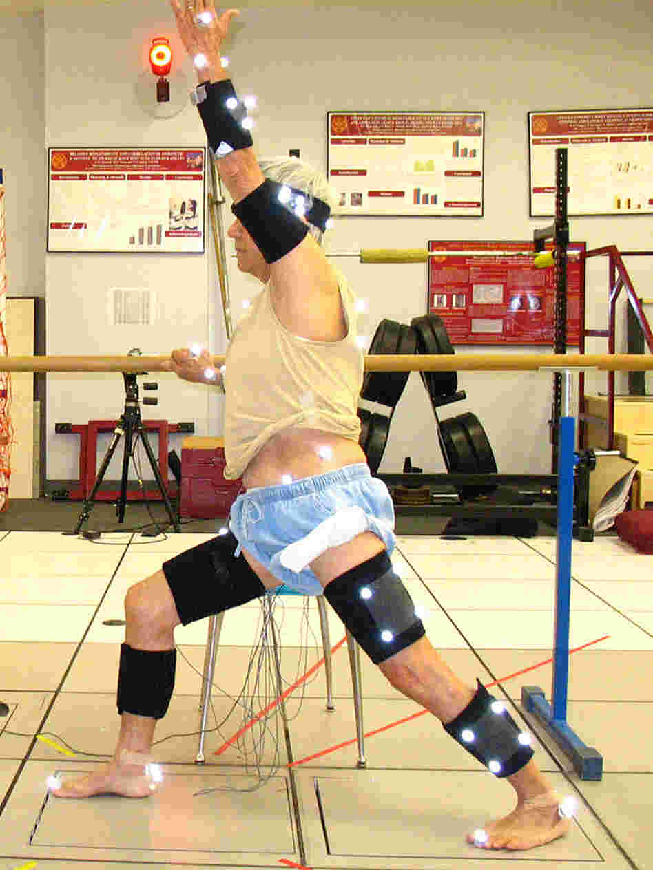 A man does yoga with sensors on.