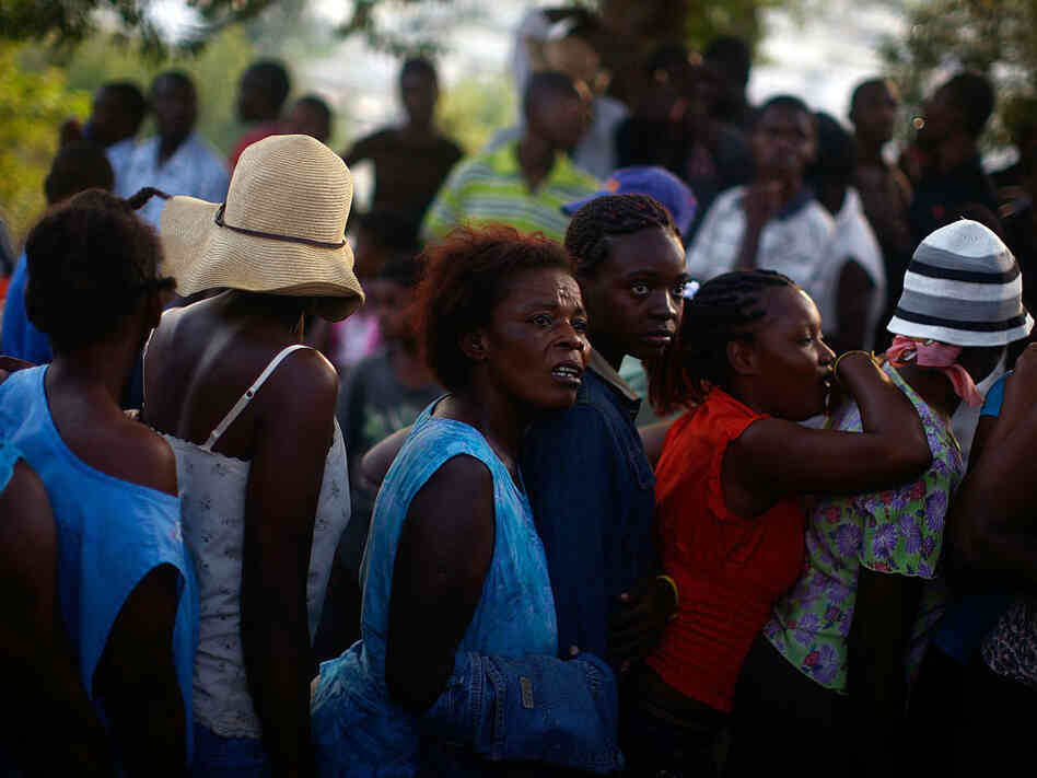 Women wait in a food distribution line in Port-au-Prince. Women wait in a food distribution line in Port-au-Prince.