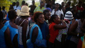 Women wait in a food distribution line in Port-au-Prince.