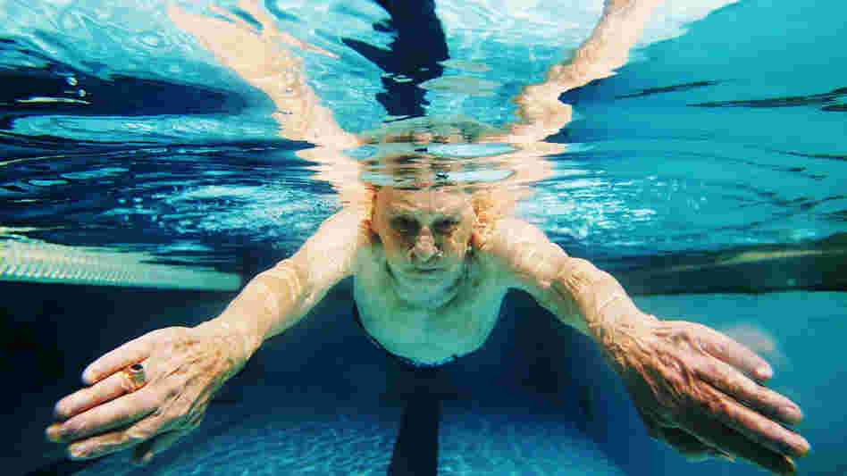 A man swims in a pool A man swims in a pool
