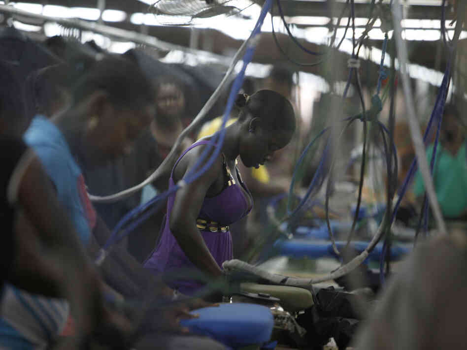 Women work at the DKDR garment assembly factory in Port-au-Prince, Haiti