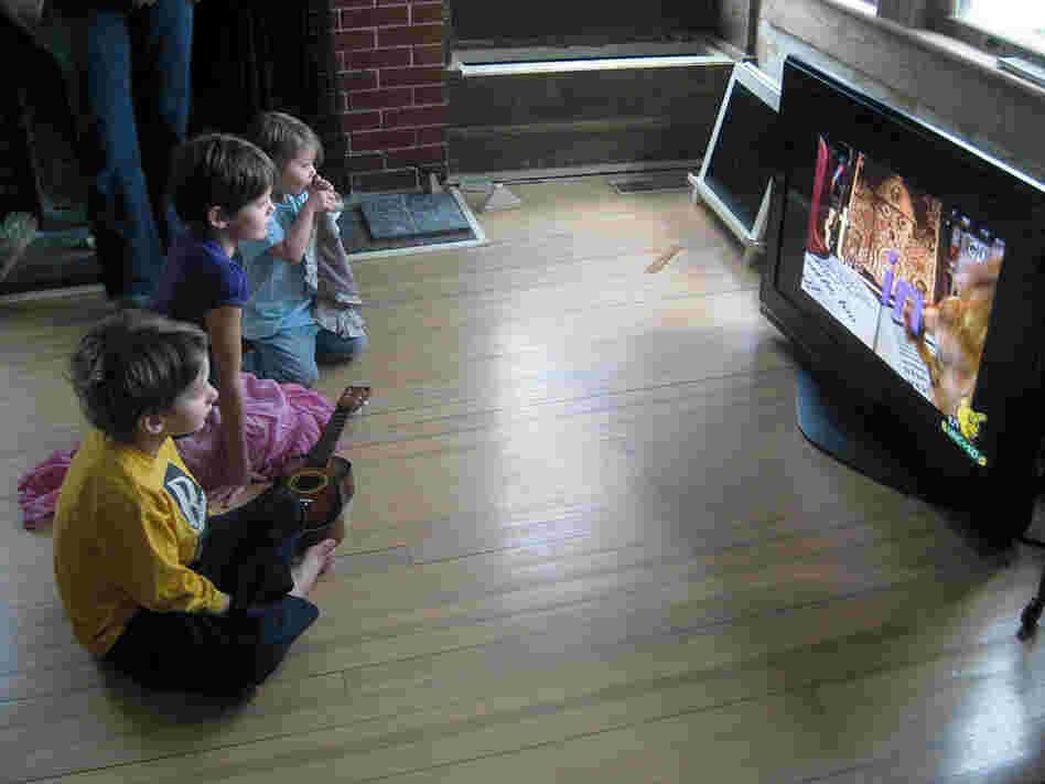 Mac, left, Veronica and Petra Humphrey watch the PBS children's channel.