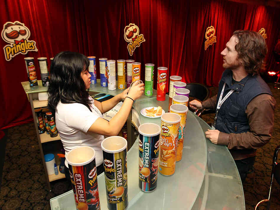 "Snacktender" Gretchen Cruz serves up chips at the "Pringles Zone."
