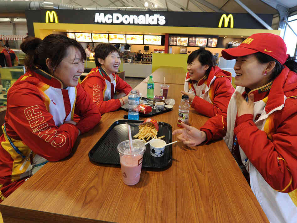 Chinese short-track speedskaters eat in the dining hall during a media tour of the Olympic Village.