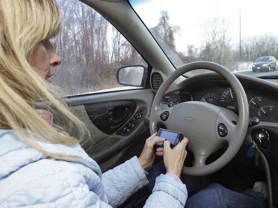 A woman texts while driving in Concord, N.H.