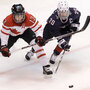 Canada's Caroline Ouellette and USA's Natalie Darwitz on the ice Thursday.  Julie Jacobson/AP