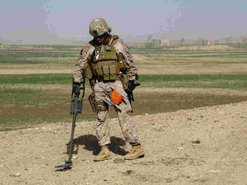A Marine sweeps for mines in the Taliban stronghold of Marjah.