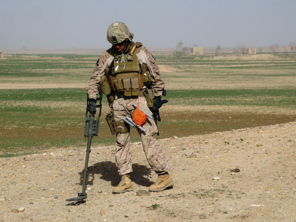 A Marine sweeps for mines in the Taliban stronghold of Marjah.