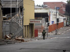 Chilean soldiers patrolled the streets of Concepcion, which were mostly deserted owing to a curfew. Chilean soldiers patrolled the streets of Concepcion, which were mostly deserted owing to a curfew.
