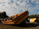A boat battered by quake-triggered waves was driven ashore near the port in Constitucion, Chile. A boat battered by quake-triggered waves was driven ashore near the port in Constitucion, Chile.