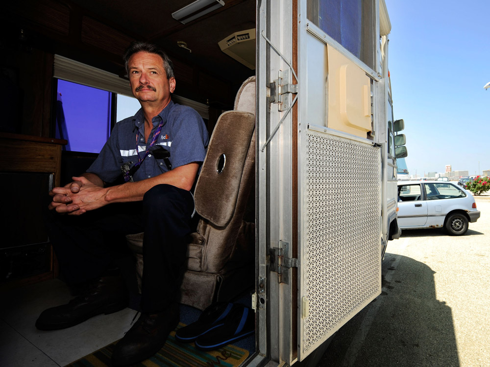 Aircraft mechanic Jere Herr of Indianapolis prepares to go to work while seated in his recreational vehicle, parked in a lot at the Los Angeles International Airport. He lives by the airport to save money for the future. One-third of Americans will have to rely on Social Security benefits — not pensions — in their retirement years.
