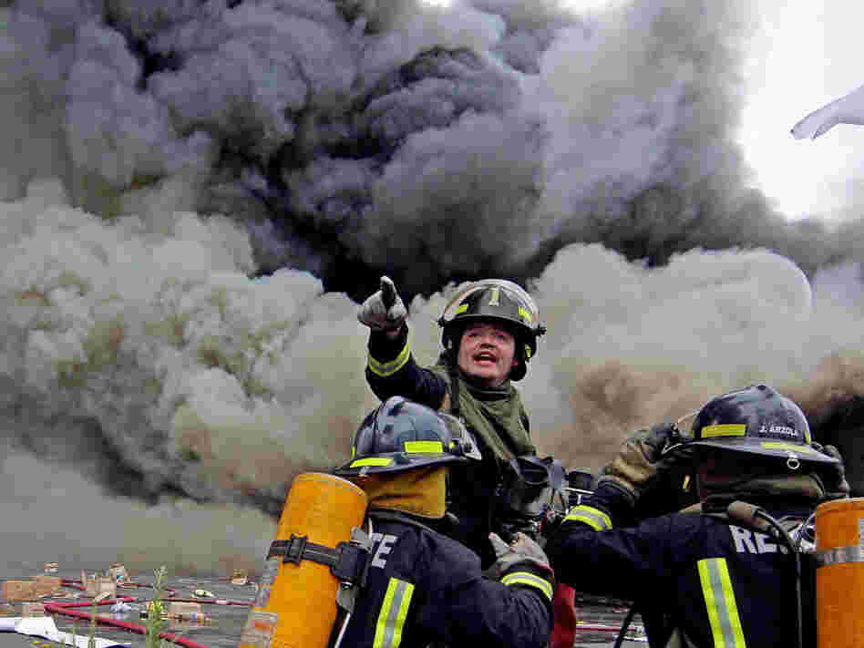 Firefighters try to control a fire at a supermarket burned by looters in Concepcion, Chile.