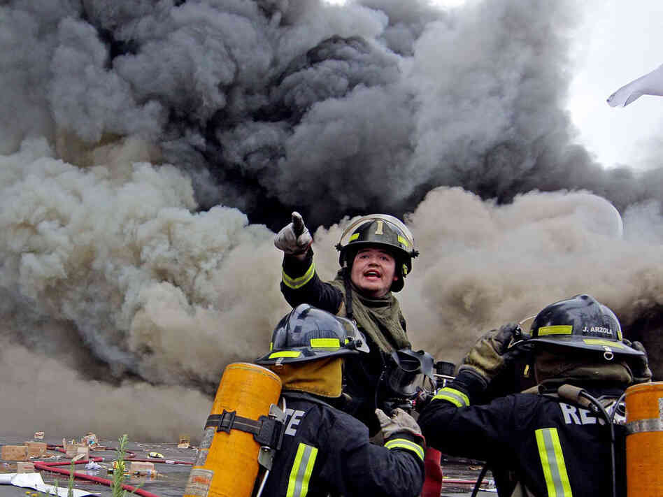 Firefighters try to control a fire at a supermarket burned by looters in Concepcion, Chile.