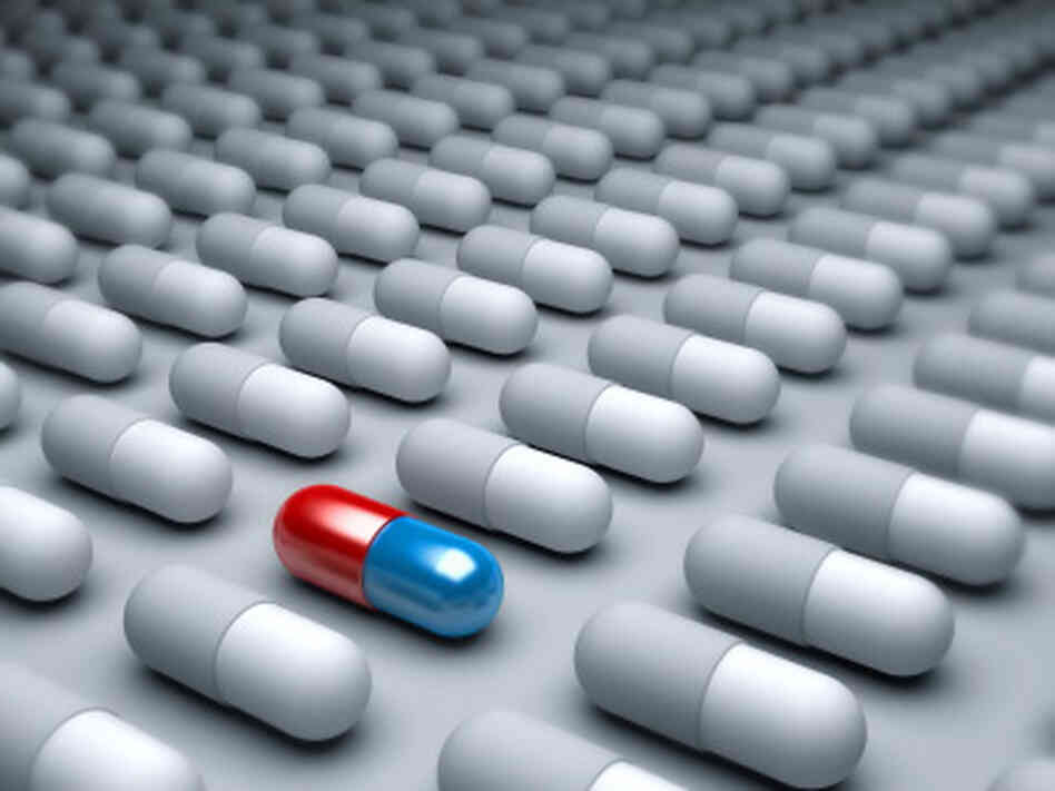 An red and blue pill amid many gray pills lined up. An red and blue pill amid many gray pills lined up.