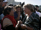 Chilean President Michelle Bachelet (right) speaks to am earthquake survivor Chilean President Michelle Bachelet (right) speaks to am earthquake survivor
