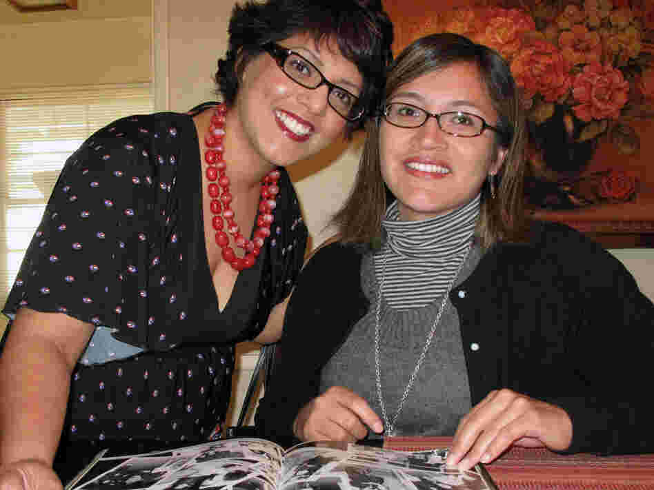 Dolores Arredondo, left, and Alicia Becerra look over their 1991 yearbook from Garfield High School.