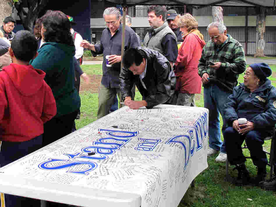 At the Garfield fundraiser, former students and community members sign a banner for Escalante.
