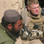 Marine Lt. Col. Brian Christmas listens as an interpreter translates concerns of Marjah residents.