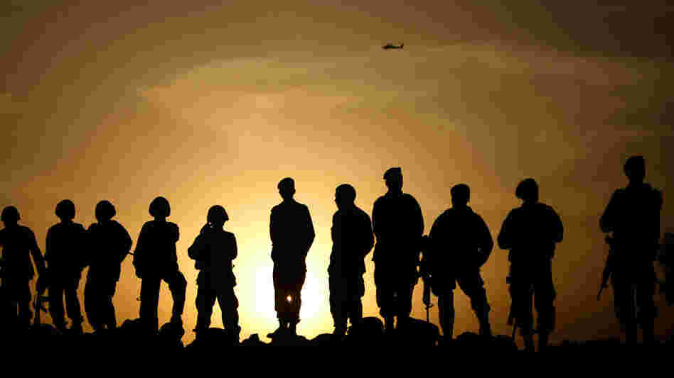 Afghan Army commandos stand on a sand bank at sunset in Marjah. Afghan Army commandos stand on a sand bank at sunset in Marjah.