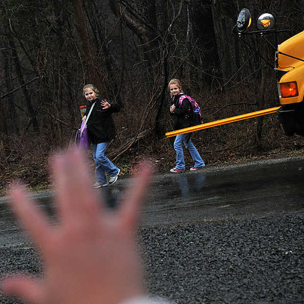 Kristy Stumpf meets her daughters at the school bus stop