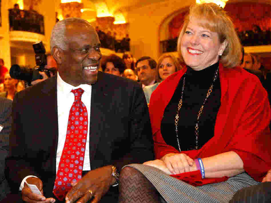Supreme Court Justice Clarence Thomas sits with his wife, Virginia Lamp Thomas.