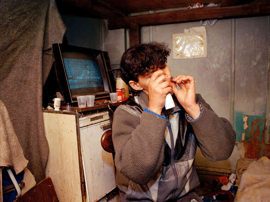 An unidentified woman smokes crack in New York, 1990.