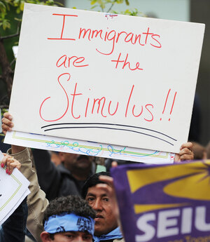 A man holds a sign at a rally A man holds a sign at a rally