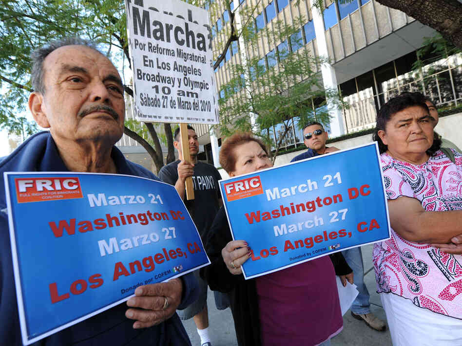 Immigration activists in Los Angeles hold signs promoting a rally in the nation's capital.