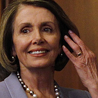 House Speaker Nancy Pelosi walks past House staff as she arrives to give a speech on health care.