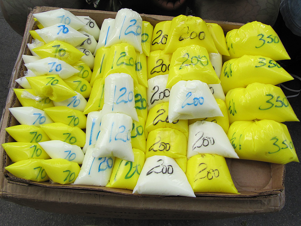 In markets in Kingston, Jamaica, women buy bleaching products sold in plastic bags without labels.