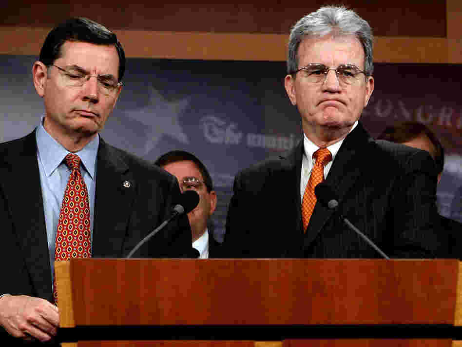 Sen. Tom Coburn of Oklahoma (right), seen with fellow Republican Sen. John Barrasso of Wyoming