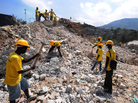 Workers remove rubble from a destroyed school in Port-Au-Prince. Workers remove rubble from a destroyed school in Port-Au-Prince.