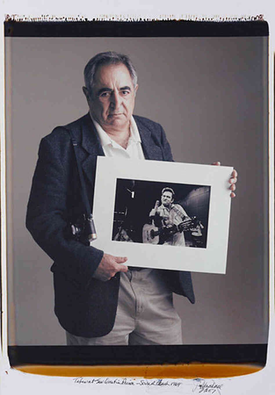 Jim Marshall with his iconic image of Johnny Cash. (Courtesy of Jim Marshall with his iconic image of Johnny Cash. (Courtesy of