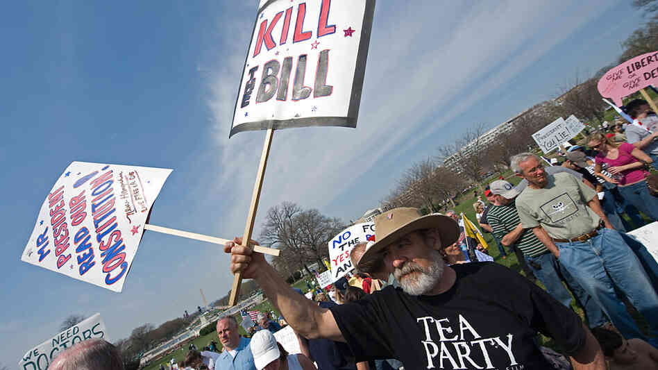 A supporter of the Tea Party movement holds a sign outside the US Capitol as they demonstrate in Was A supporter of the Tea Party movement holds a sign outside the US Capitol as they demonstrate in Was
