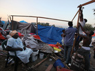 Earthquake survivors construct a makeshift encampment on a golf course in Port-au-Prince. Earthquake survivors construct a makeshift encampment on a golf course in Port-au-Prince.