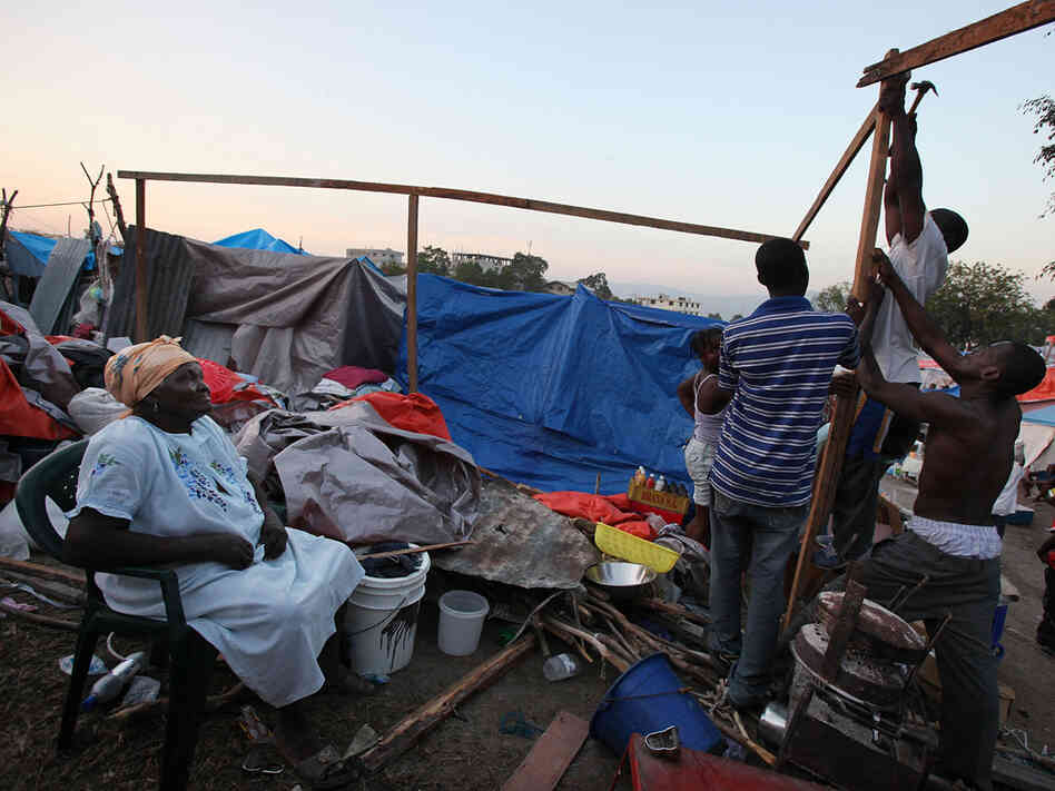 Earthquake survivors construct a makeshift encampment on a golf course in Port-au-Prince.