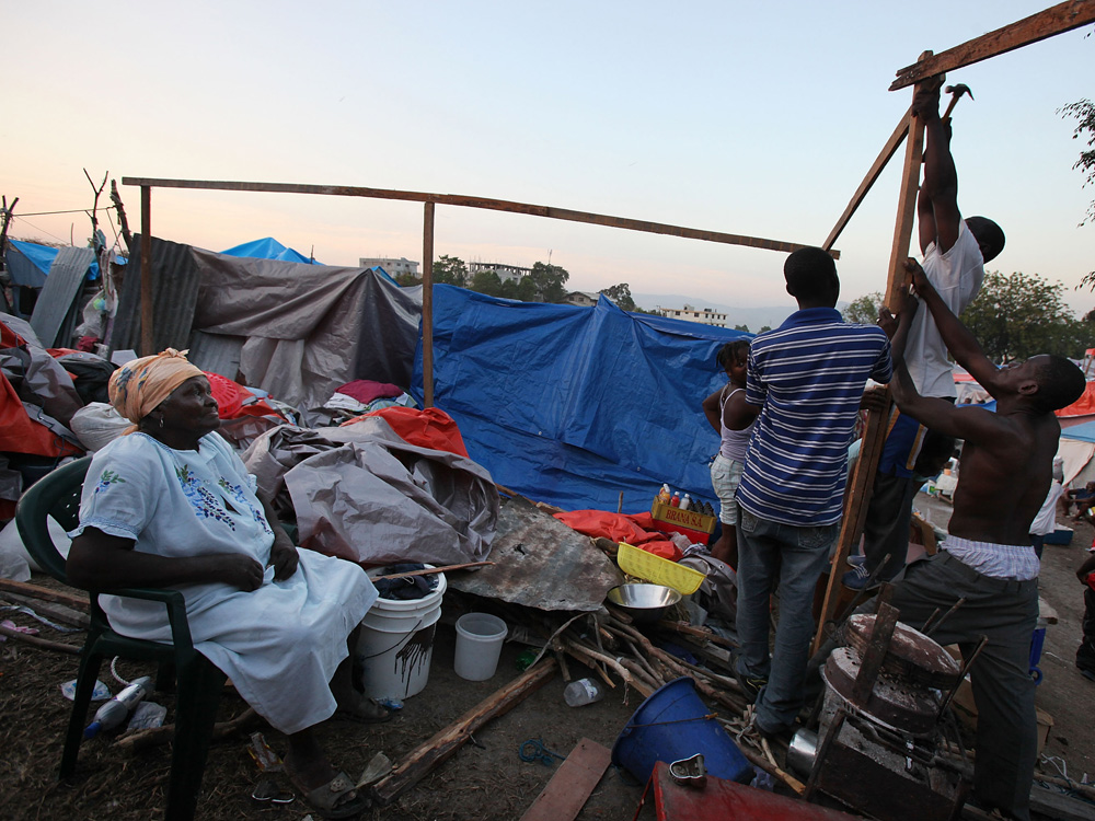 Earthquake survivors construct a makeshift encampment on a golf course in Port-au-Prince.