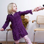 A child tugs away from her mother.