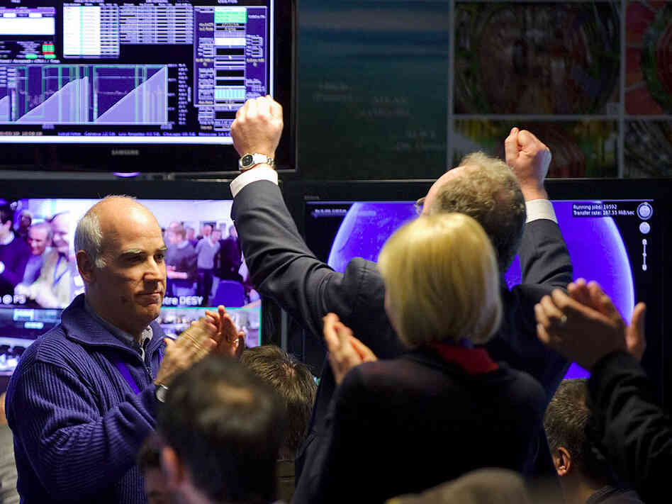 Scientists celebrate after the Large Hadron Collider started smashing protons at record power.