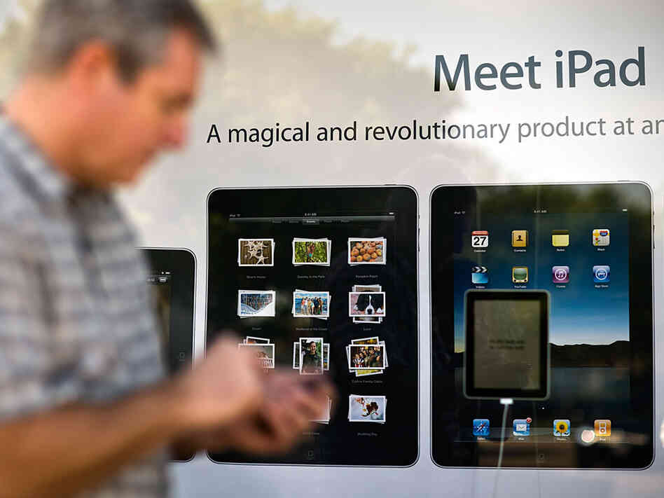 A customer waits in line outside an Apple store