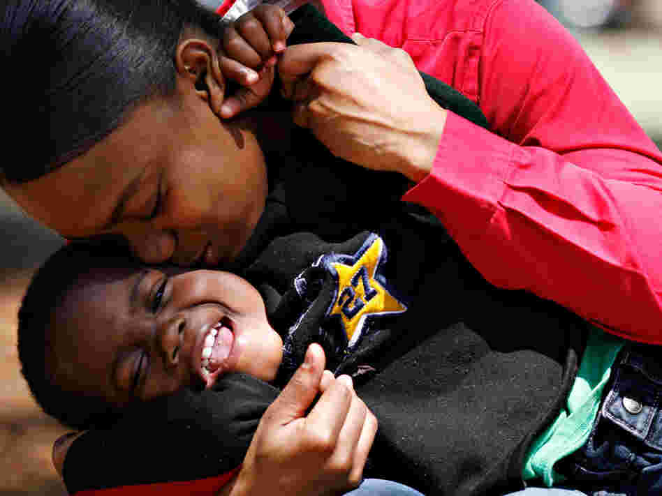 Katrena Wingo, who spent most of her life in foster care, kisses her son.