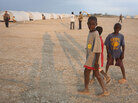 Children walk through their new home at a camp in Corail-Cesselesse, Haiti. Children walk through their new home at a camp in Corail-Cesselesse, Haiti.