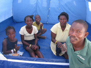 Louis Sainte Claudelle and his family in their tent at Corail-Cesselesse Louis Sainte Claudelle and his family in their tent at Corail-Cesselesse