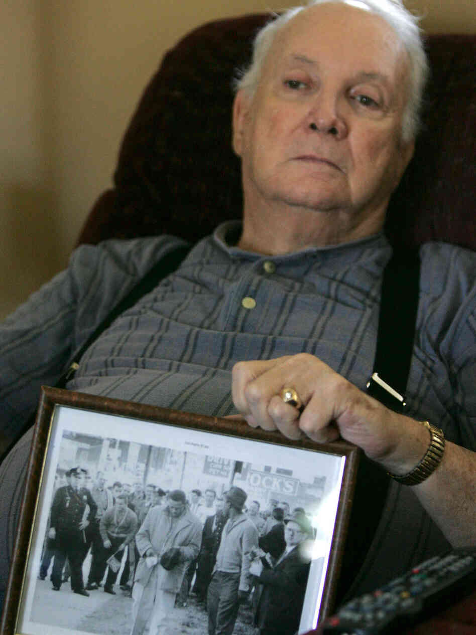Elwin Wilson holds a photo of the mob he participated in in 1960. Elwin Wilson holds a photo of the mob he participated in in 1960.
